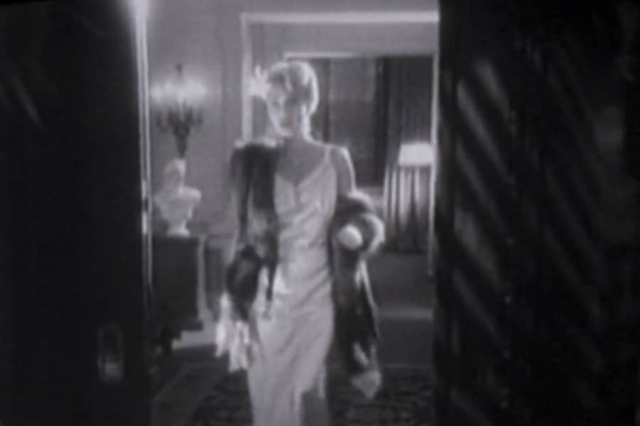 a sharply dressed woman enters a room