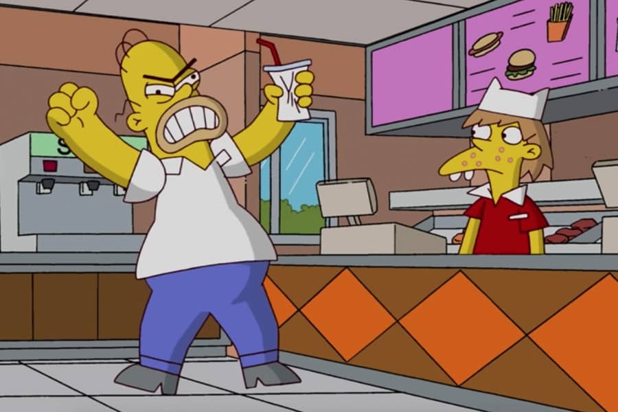 Homer is angry, crumpling his drink cup in a fast food restaurant