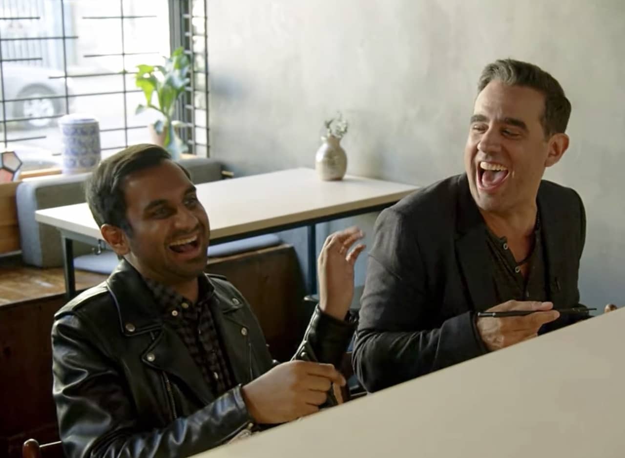 Dev and Jeff laughing while eating at a restaurant counter