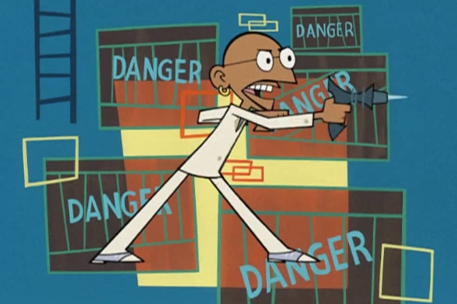 Tandoori pointing a gun with “Danger” signs behind him