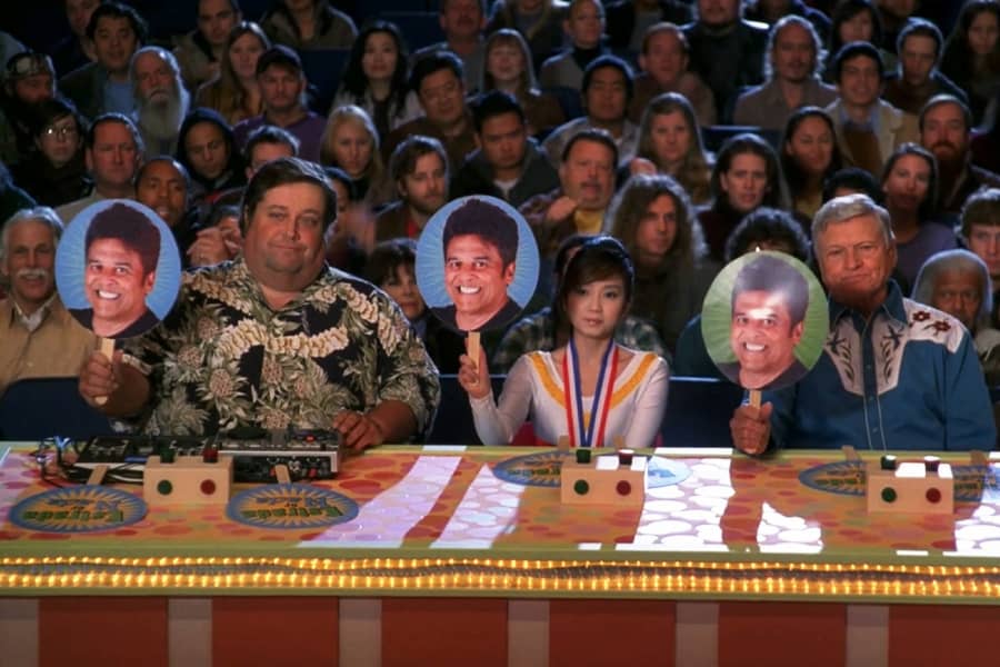 panel of judges holding up three Estrada scores