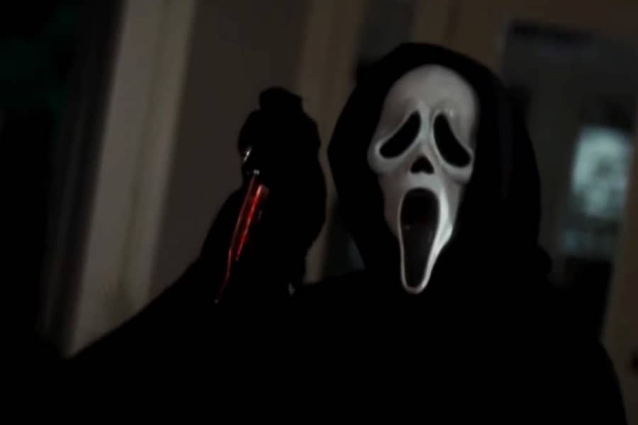 Ghostface holds up a bloody knife