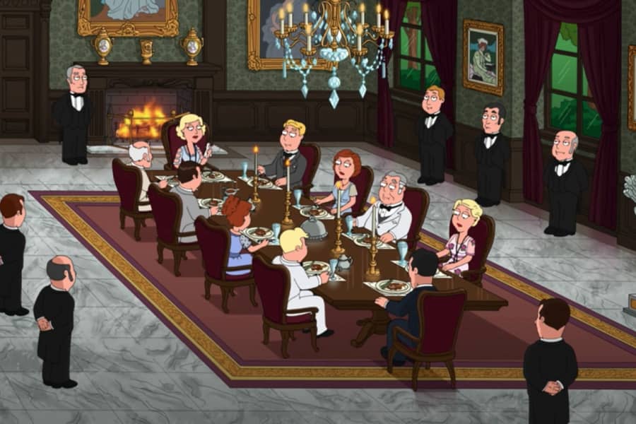 a large dining room with fancily-dressed people sitting at a long table, many butlers stand at the edges of the room