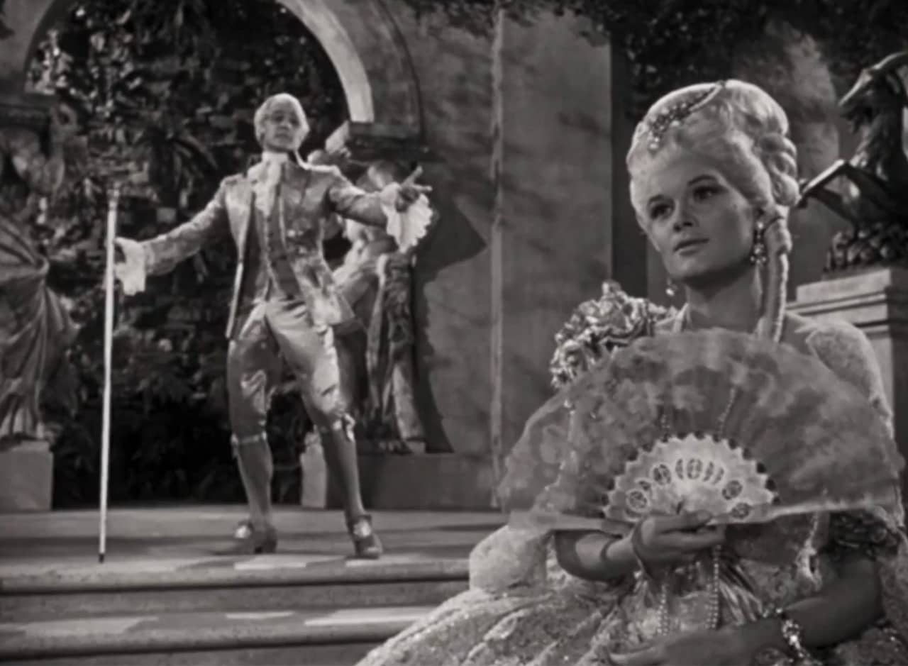 Lina Lamont as Yvonne in French dress with Don Lockwood in the background as the courting Count Pierre