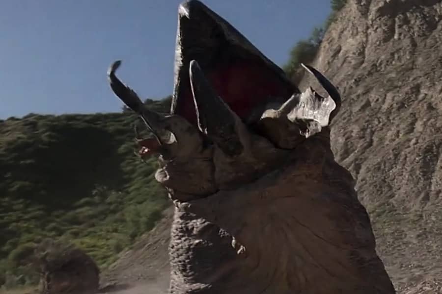 a graboid monster emerging from the sand