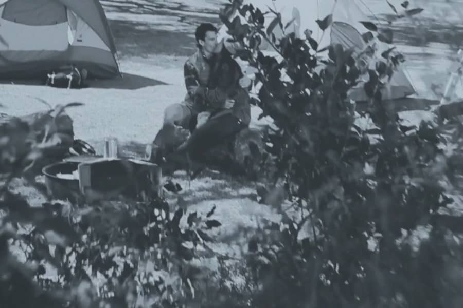 two teens kissing at a campground
