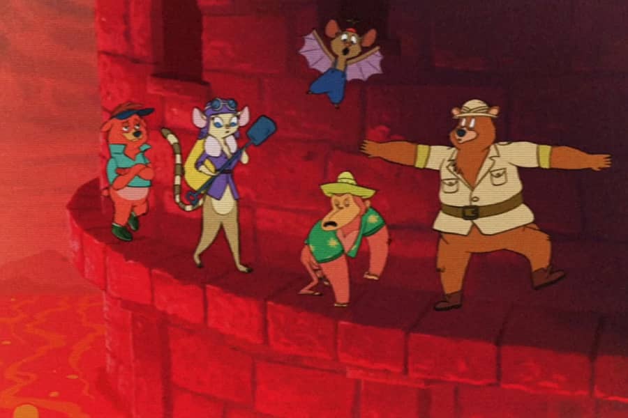 the gang walking along a ledge with red lava below