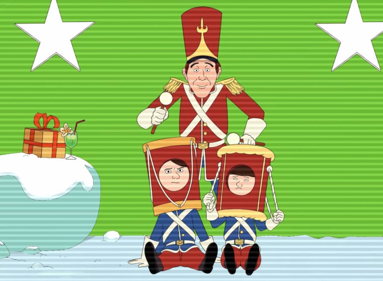 Bing Crosby dressed as a nutcracker, banging two drums on his two young sons’ heads