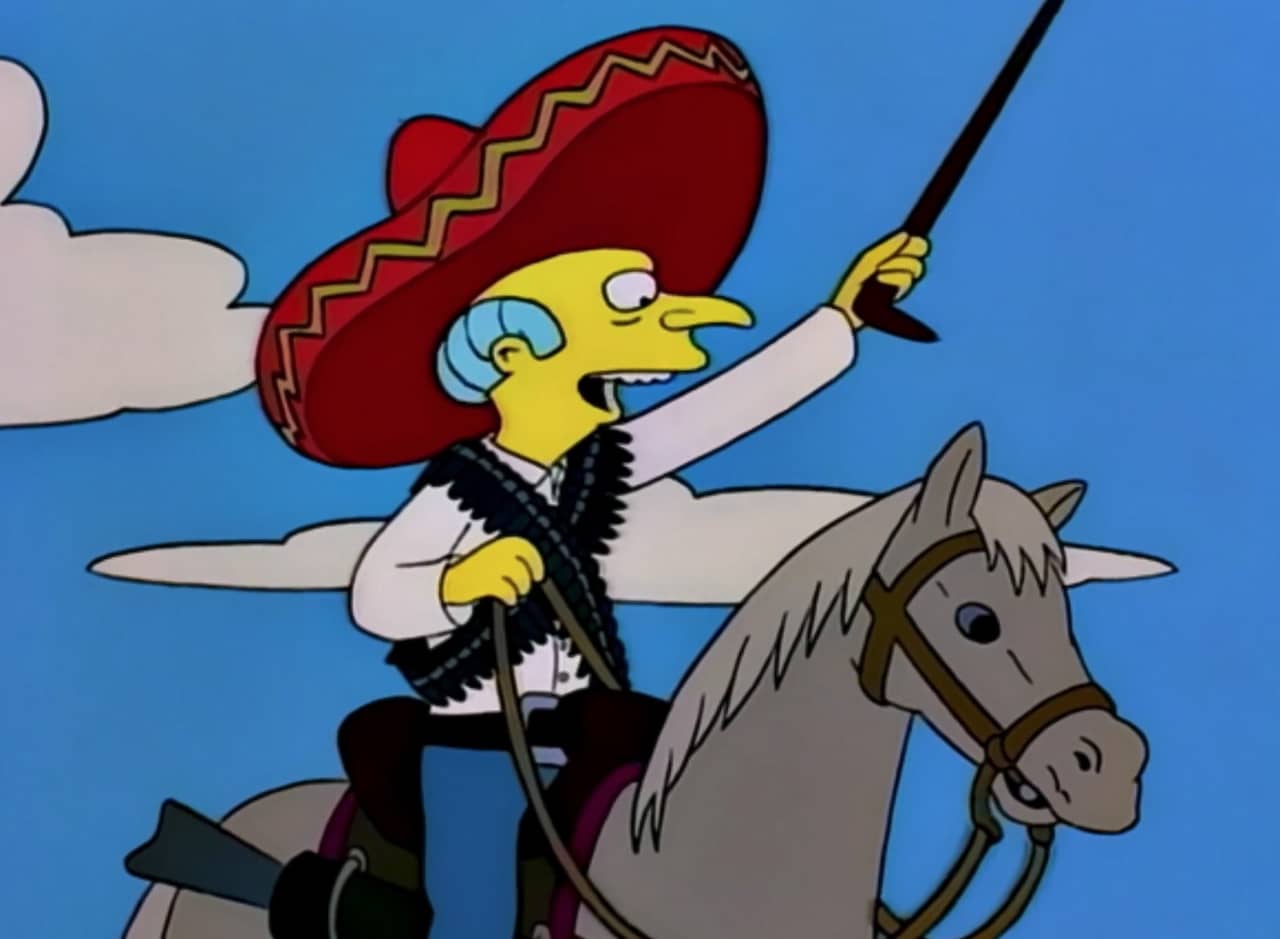 Mr. Burns, wearing a sombrero, rides a horse and raises a cane with open-mouthed excitement