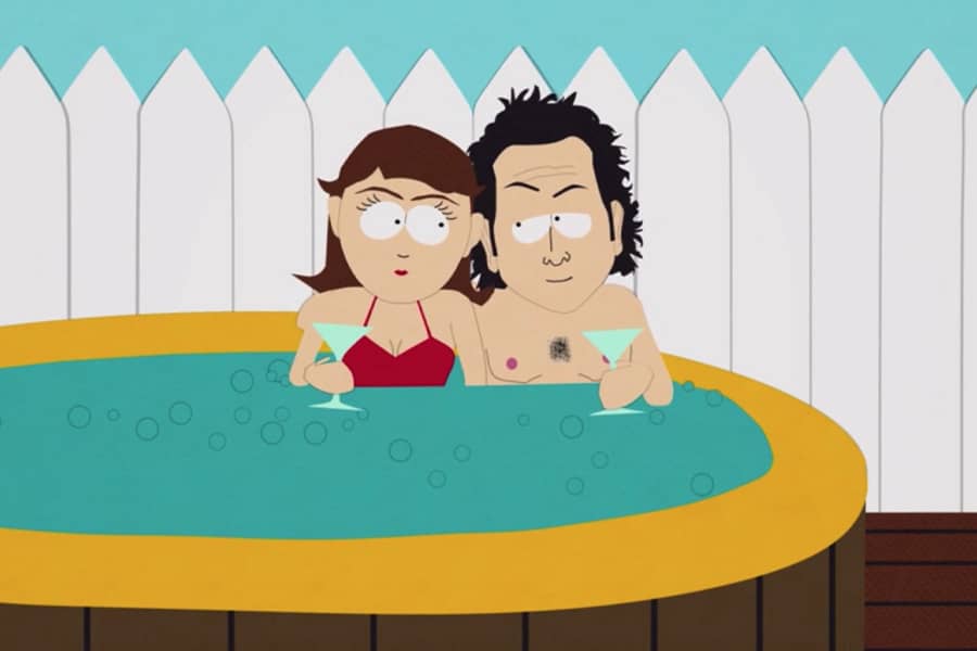 Rob and woman drinking martinis in a hot tub