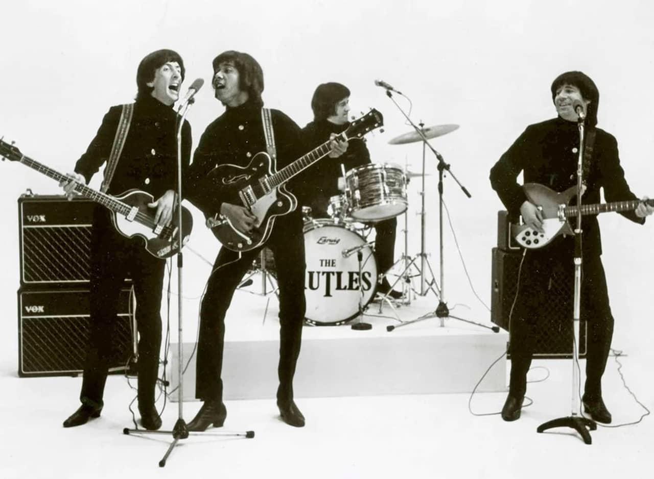 the Rutles performing on a white sound stage