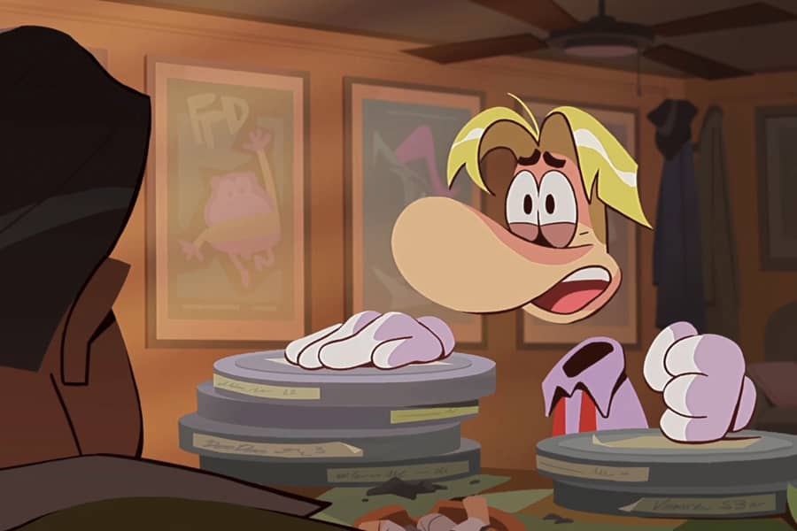 Rayman talking to an agent with his hands on a bunch of film reels