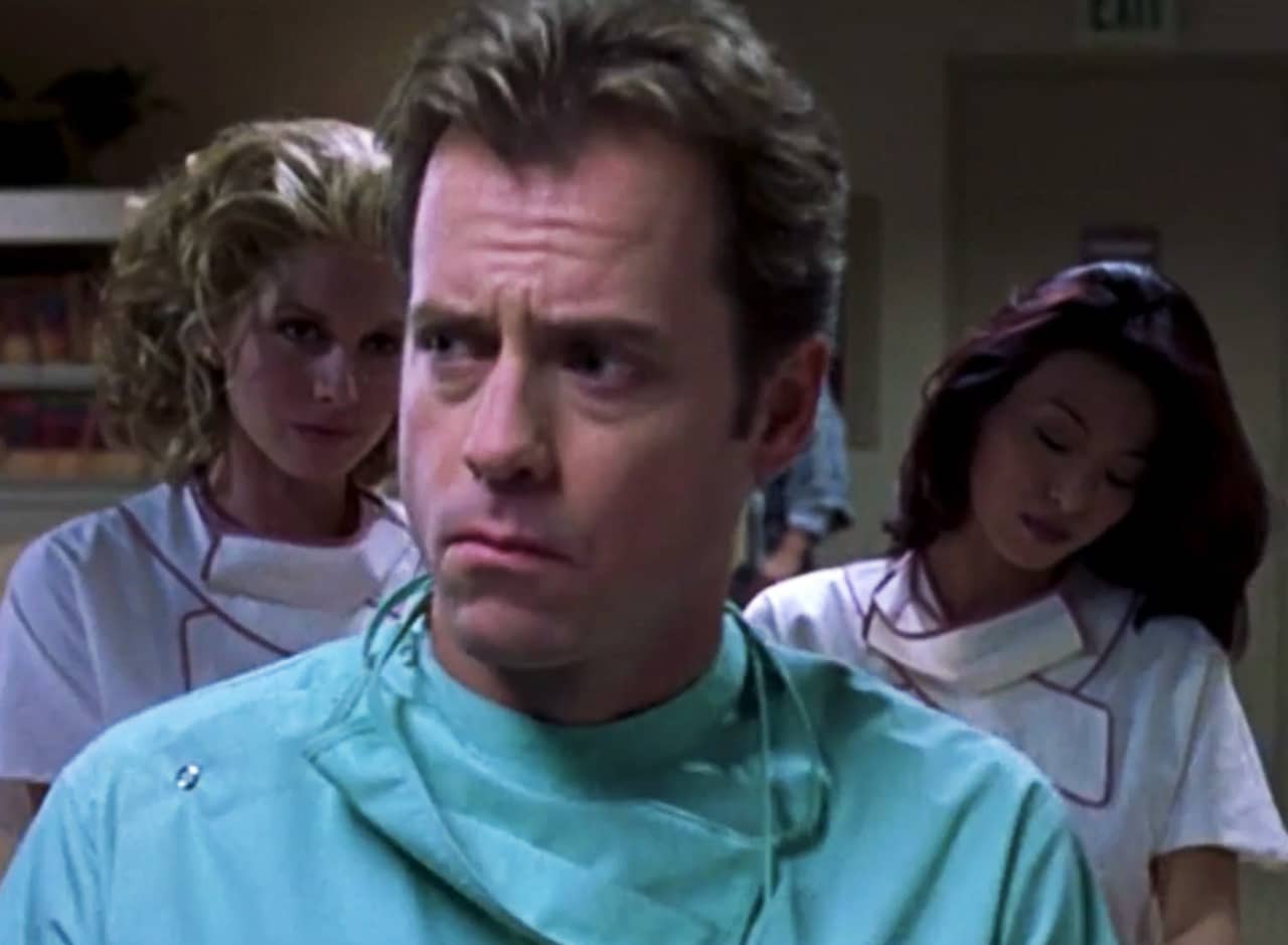 a doctor with furrowed brow and two beautiful nurses