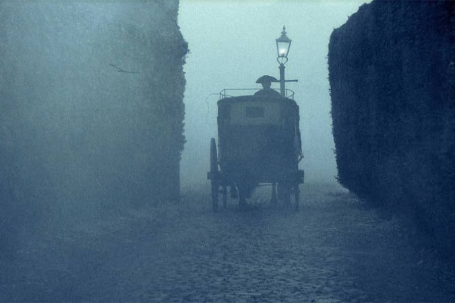 horse-drawn carriage on a foggy night