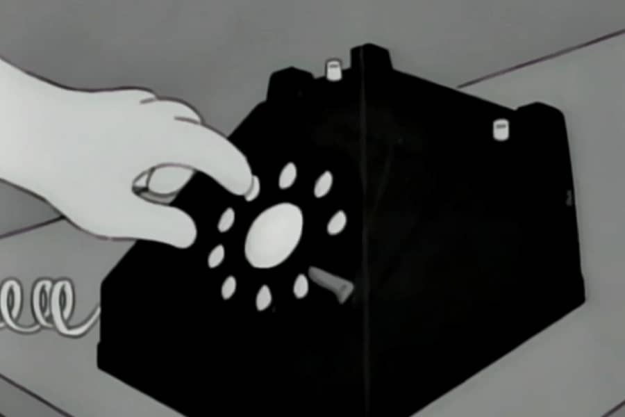 finger dialing a rotary phone