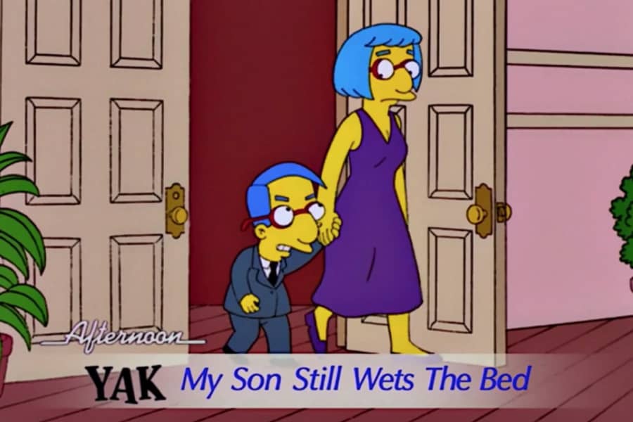 an angry Milhouse and his mother walk through a door and a chyron says “My son still wets the bed”