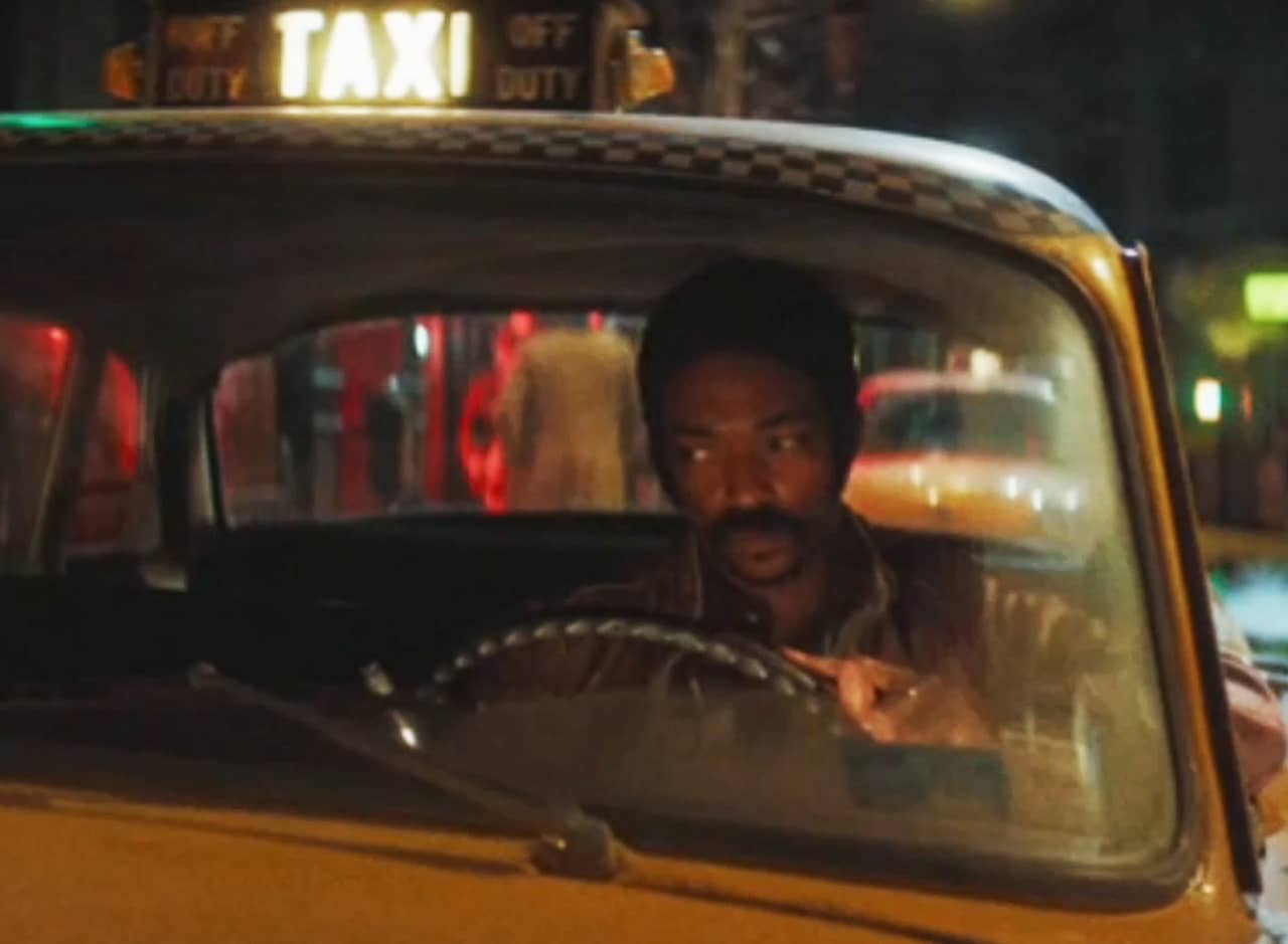 Anthony Mackie in a city taxi