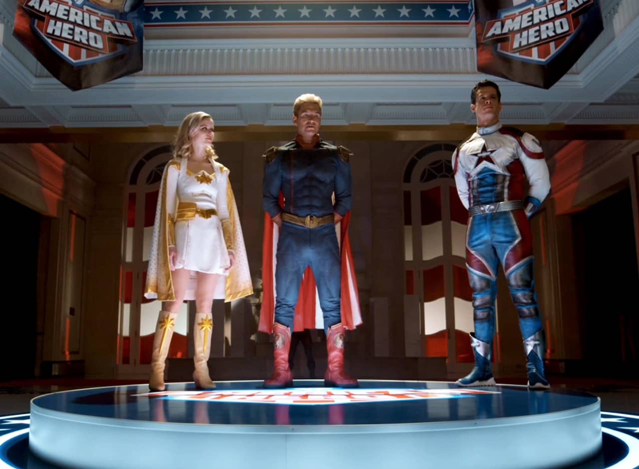 dramatically lit stage with Homelander, Starlight, and Supersonic