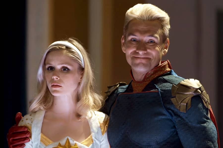 Homelander with his arm around Starlight’s shoulder and he is grinning at the camera
