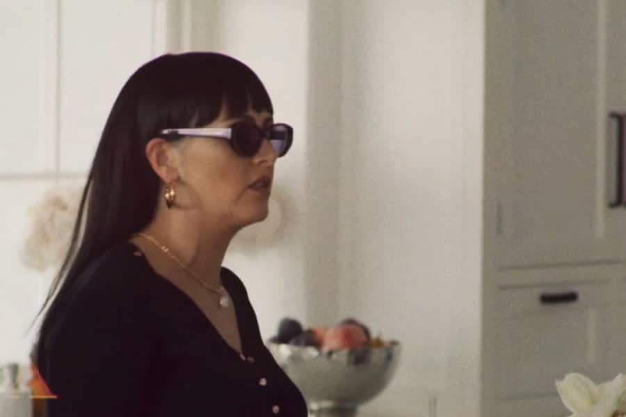 an adult daughter with long black hair, neat bangs and sunglasses