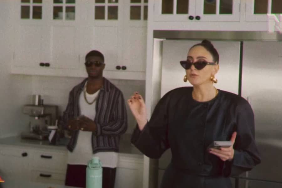 another daughter with top bun, a relaxed Black man stands behind her