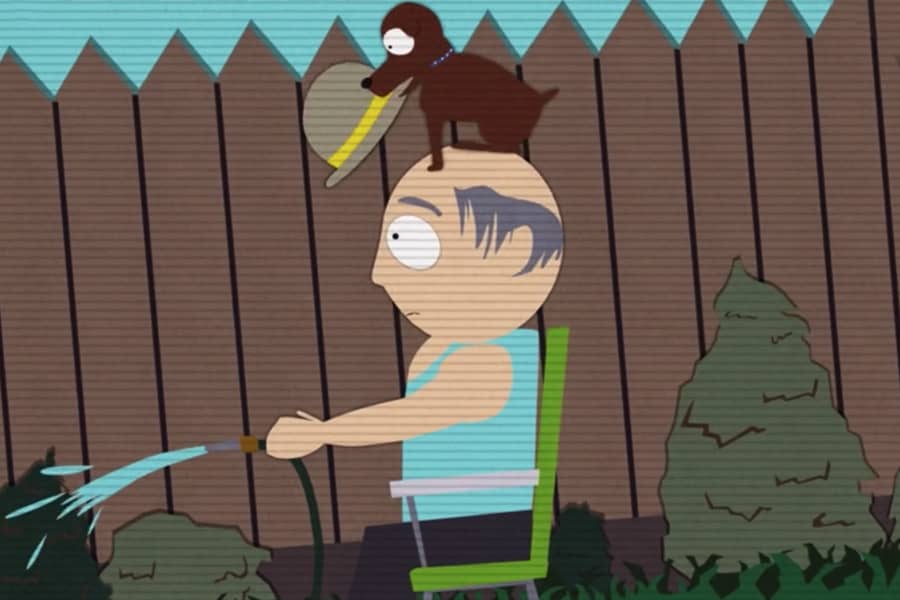 home video of a dog putting a hat on a guy watering his lawn