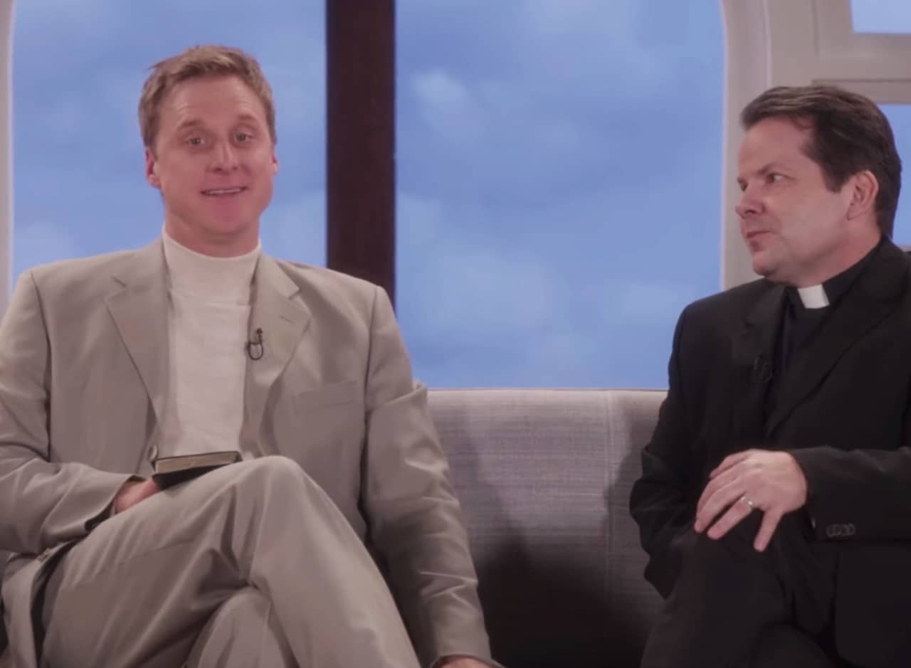a pastor and a priest sit on a talk show couch