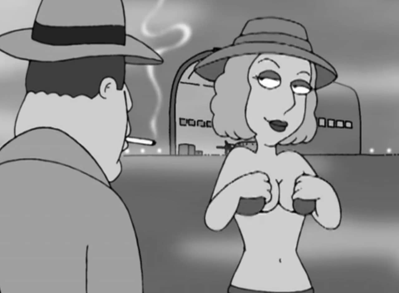 the scene is an airplane hangar and a man with fedora and cigarette watches a woman remove her bra