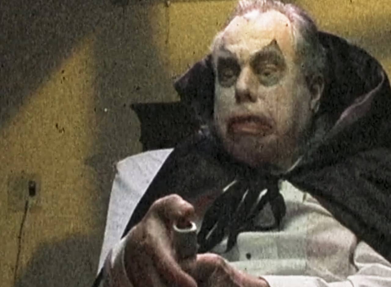 very old man Dracula trying to push a nurse call button