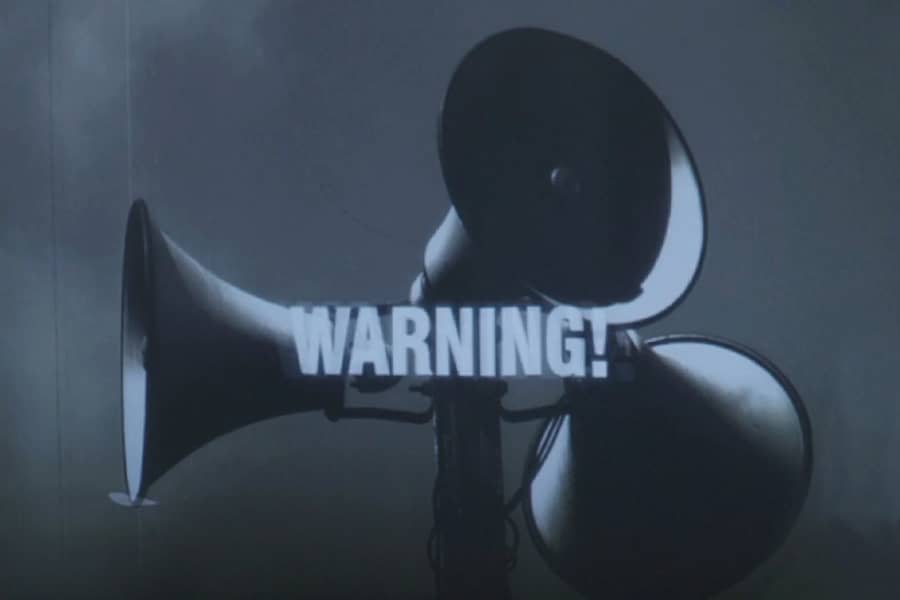 outdoor warning sirens with text “Warning!”