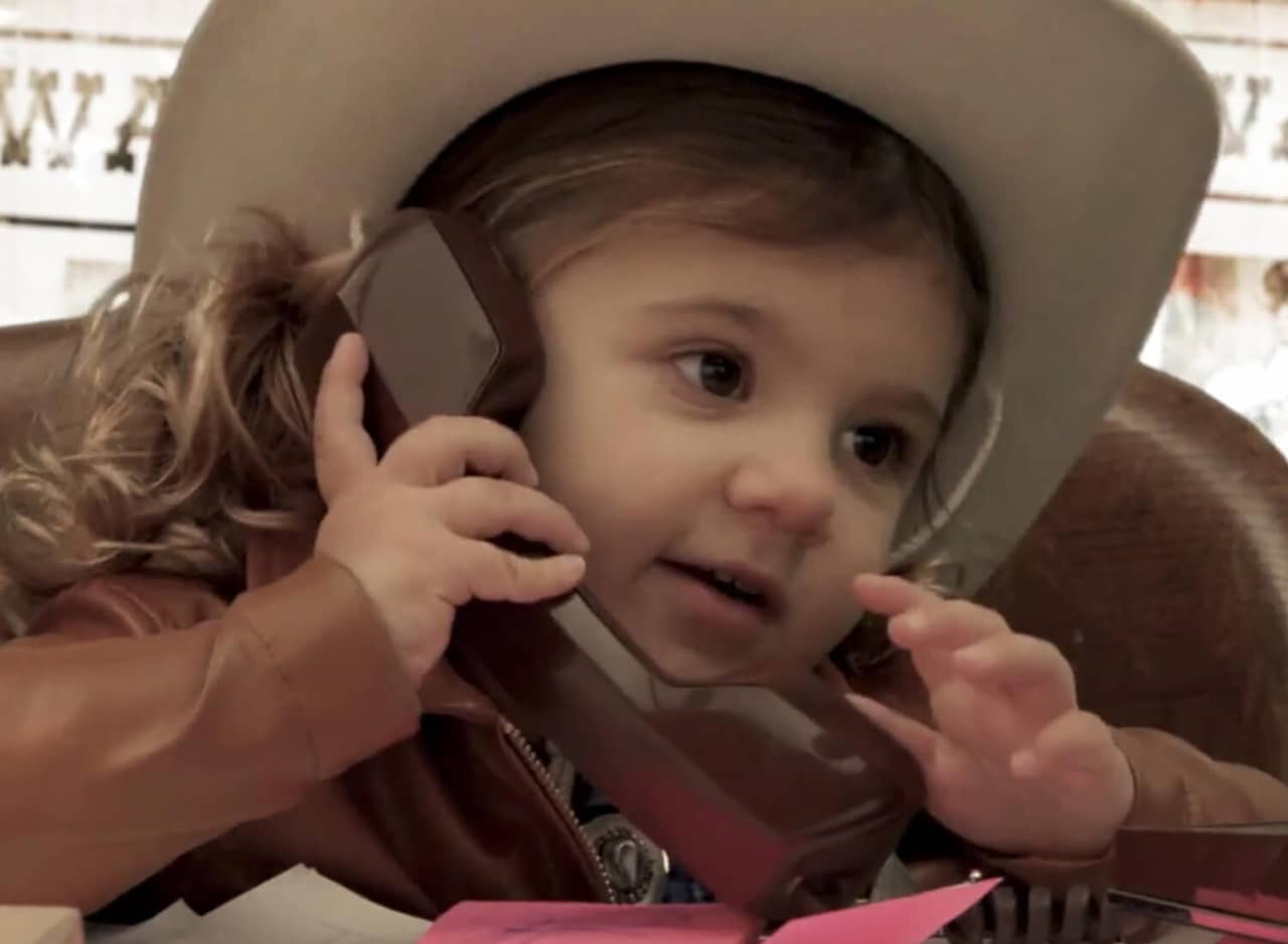 a baby sheriff on the telephone