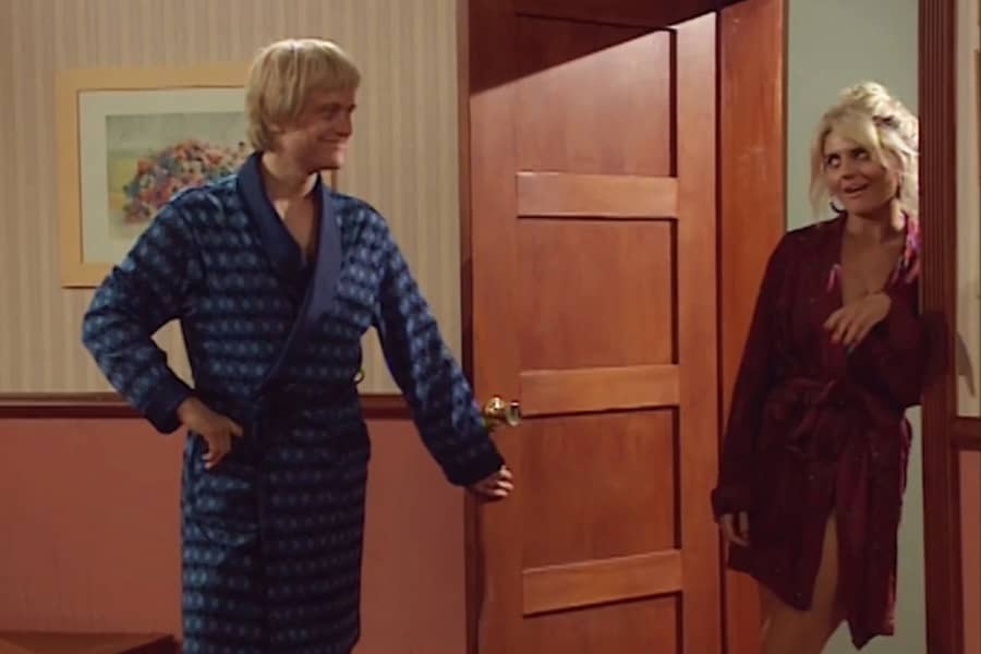 Dieter Dalmer in a robe, opening the door for a woman in a robe