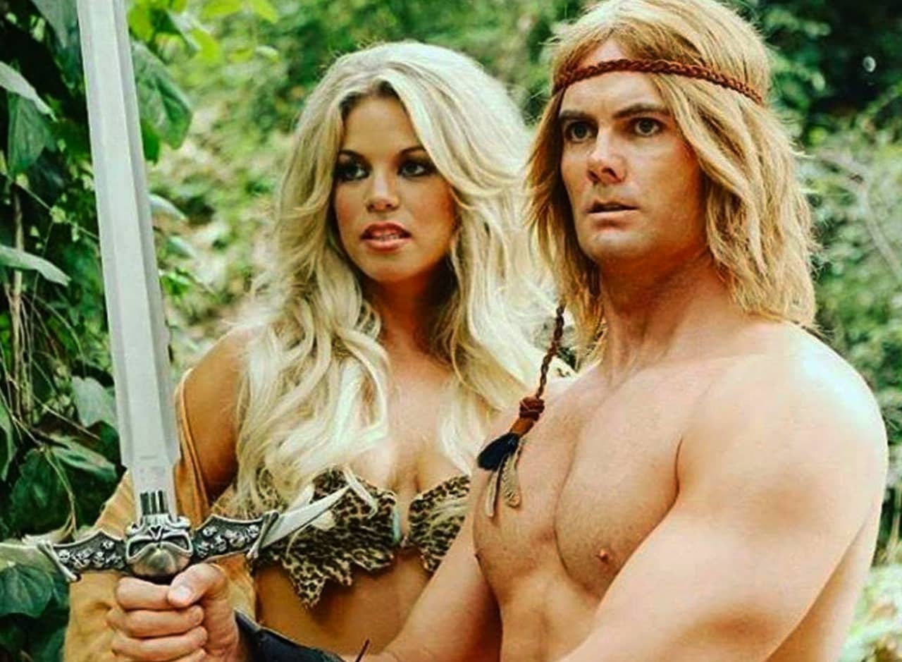 Beast Wizard, a buff shirtless hero holding a sword, and a blonde scantily-clad woman