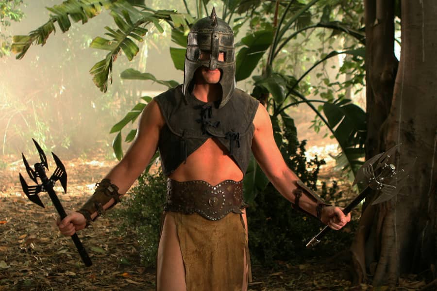 villain in armor and holding two weapons