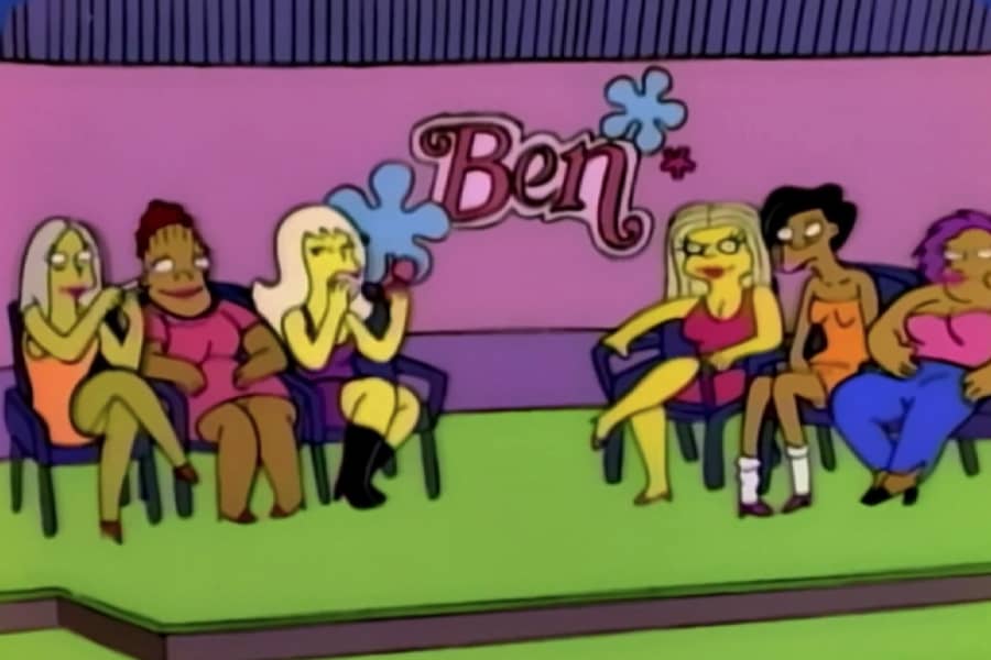 six women sitting in chairs on a talk show stage