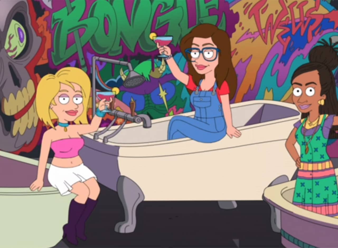 three women toasting cocktails while standing in bathtubs on a graffiti-covered rooftop