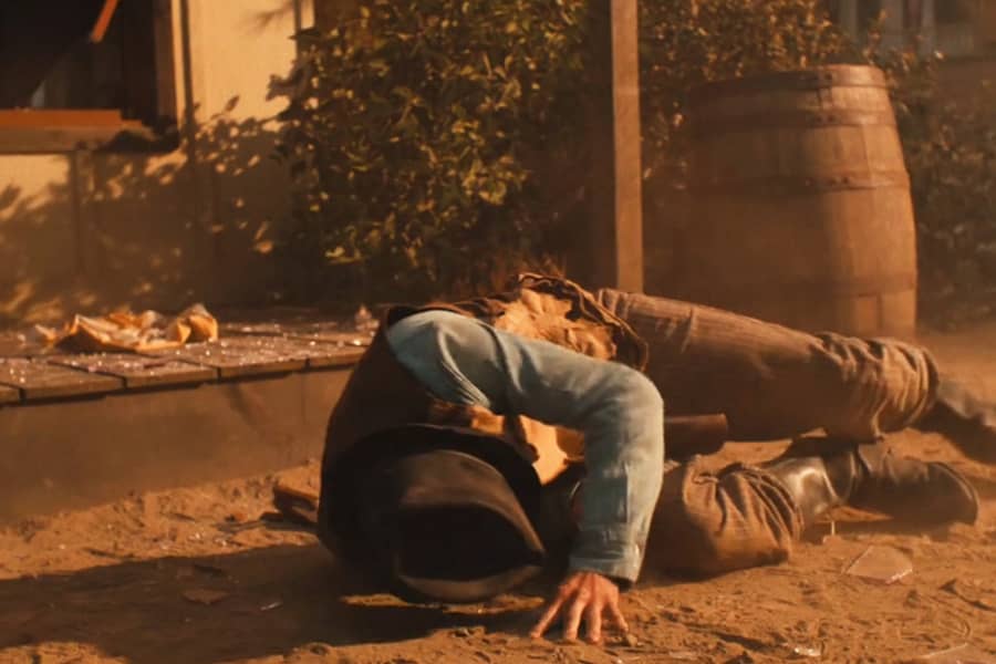 Billy on the ground near a broken window