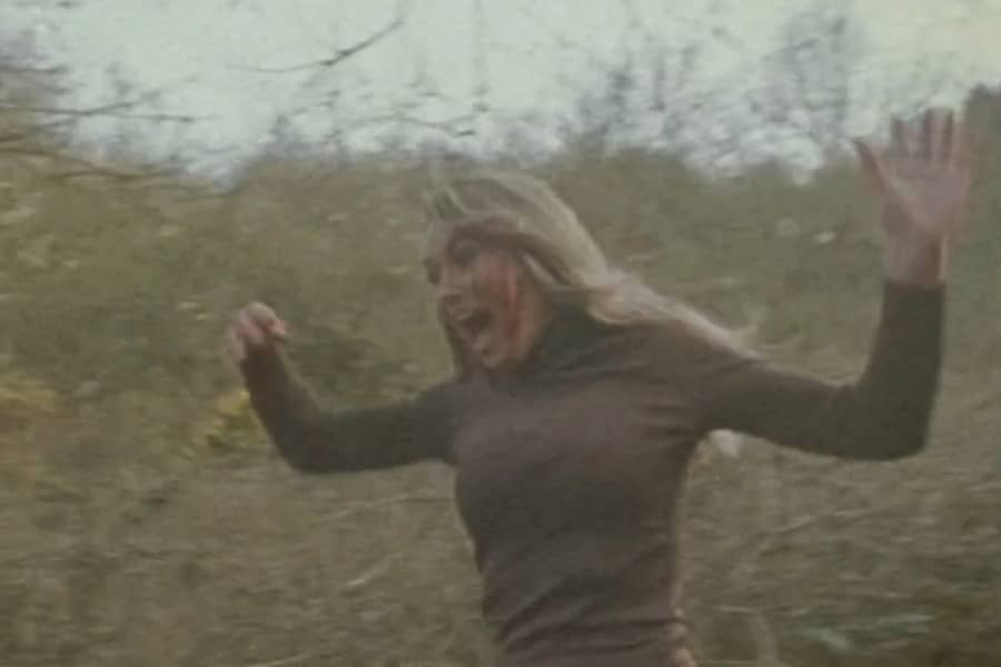 young woman running and screaming through some brush