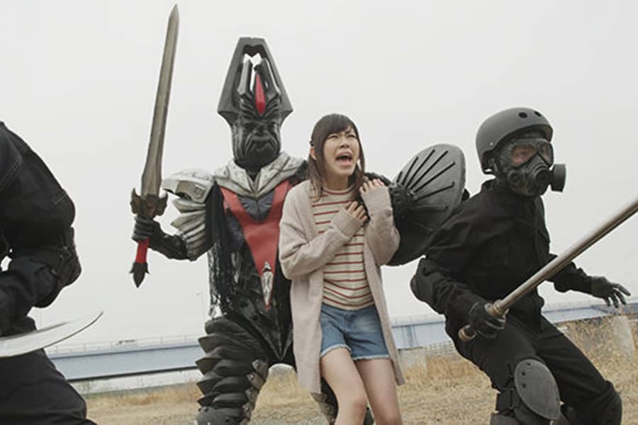 villain Satanzorg holds a young lady hostage