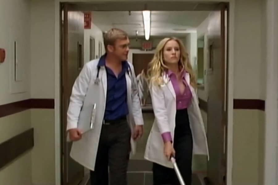 Cole and Claire walk down a hospital hallway