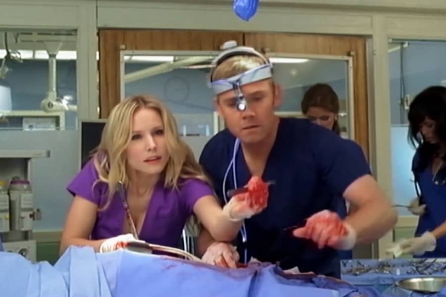 Claire holds a scalpel as she and Cole work on a patient