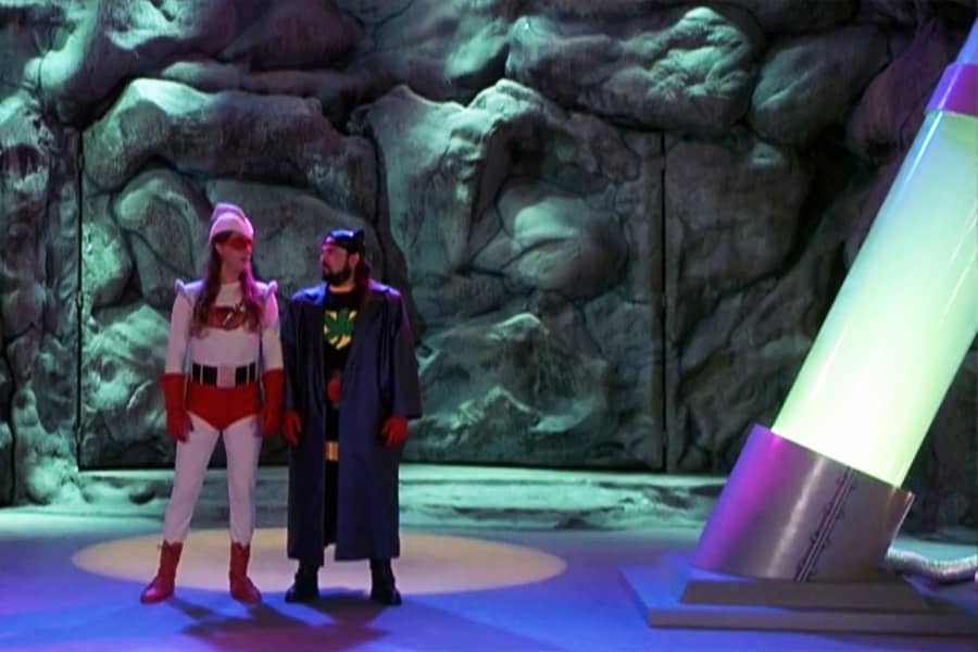 Jay and Silent Bob in superhero garb in a cave lair