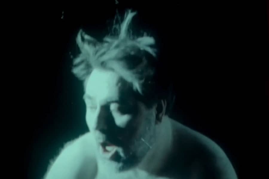 man’s face as he bounces, hair flying