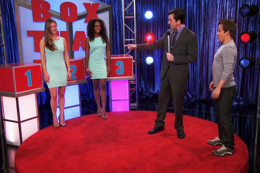 contestant talking to the host and looking at 3 numbered boxes