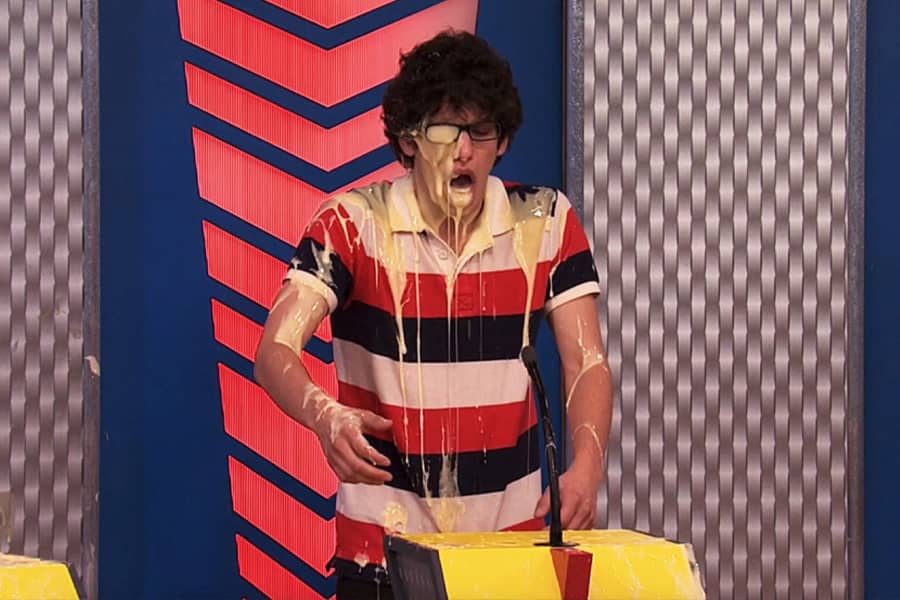 teen boy convered in cream-colored goop