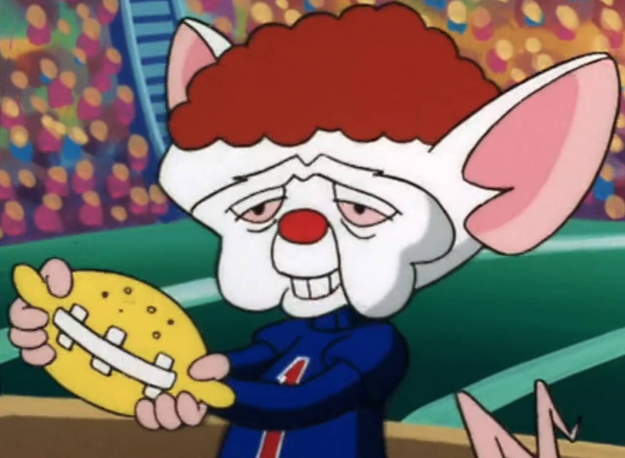 Brain Piccadilly, mouse with curly red hair, holding a lemon that looks like a football