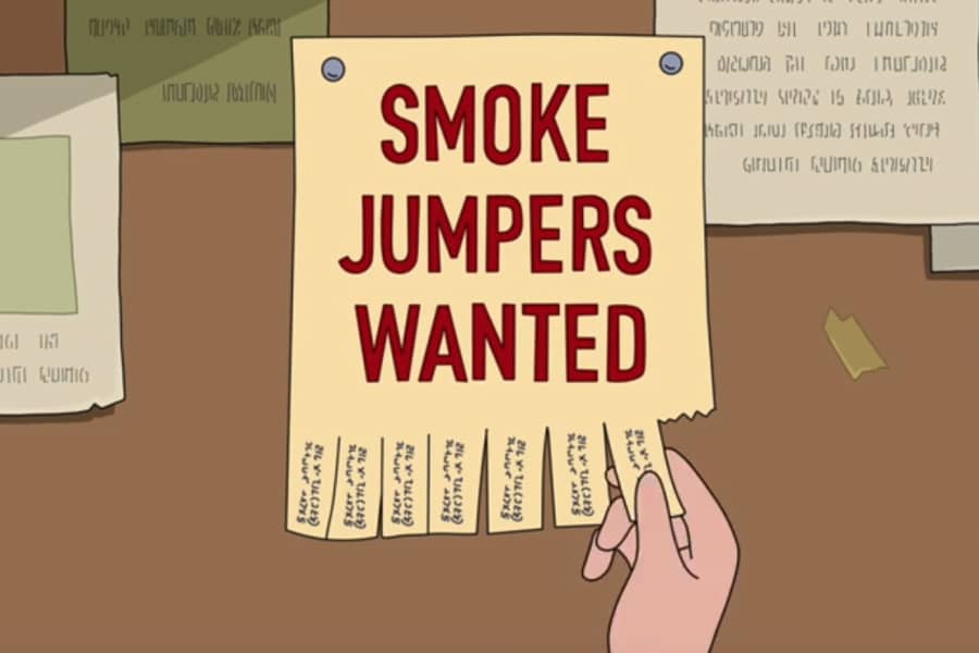 hand ripping off an ad that says “smoke jumpers wanted”