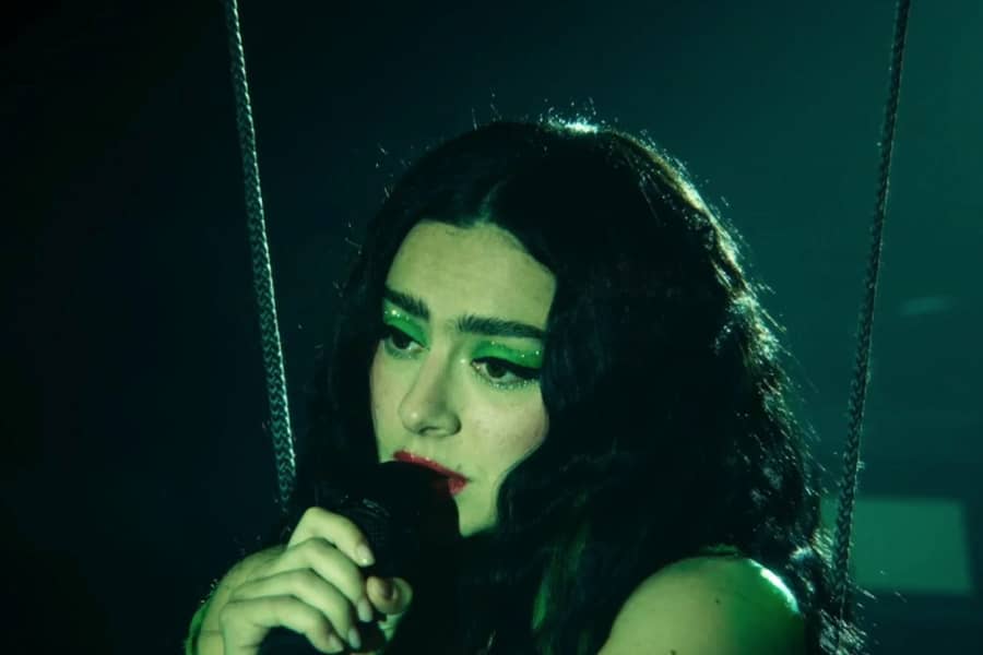 Charli xcx singing while hanging from wires