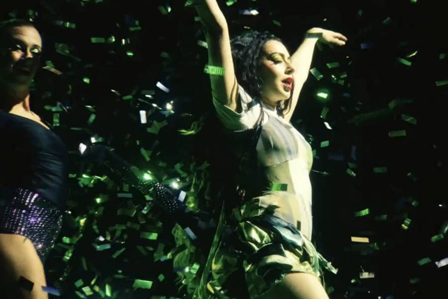 Charli xcx strutting with confetti falling around her