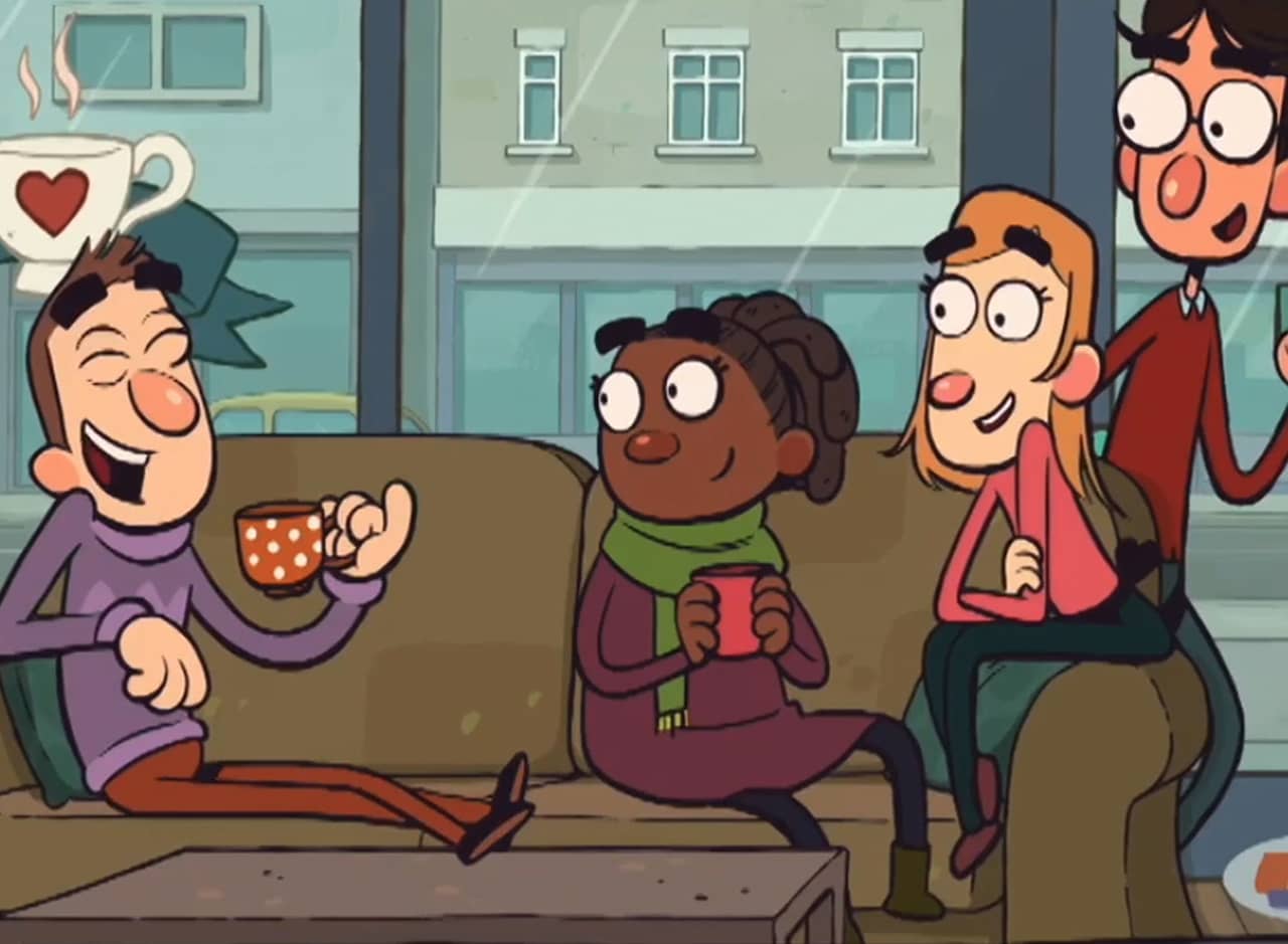 four friends drinking coffee on a couch in a coffee shop